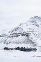Deplar Farm covered in snow with a mountain behind it.